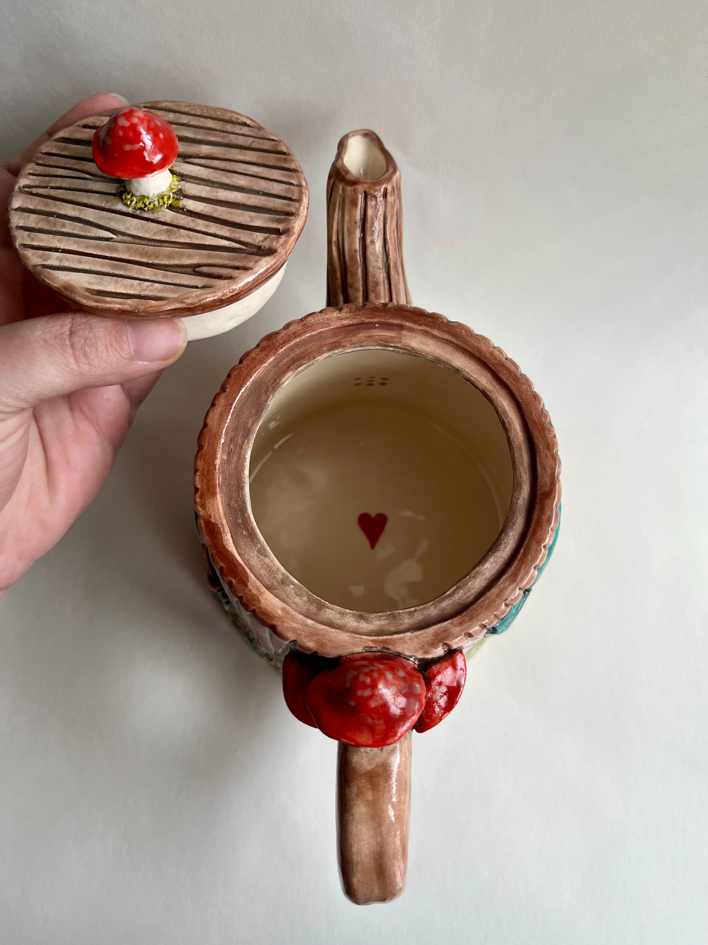 Rosa in the tree stump house teapot